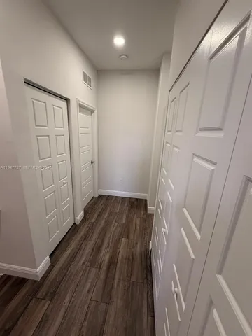 a view of room with wooden floor