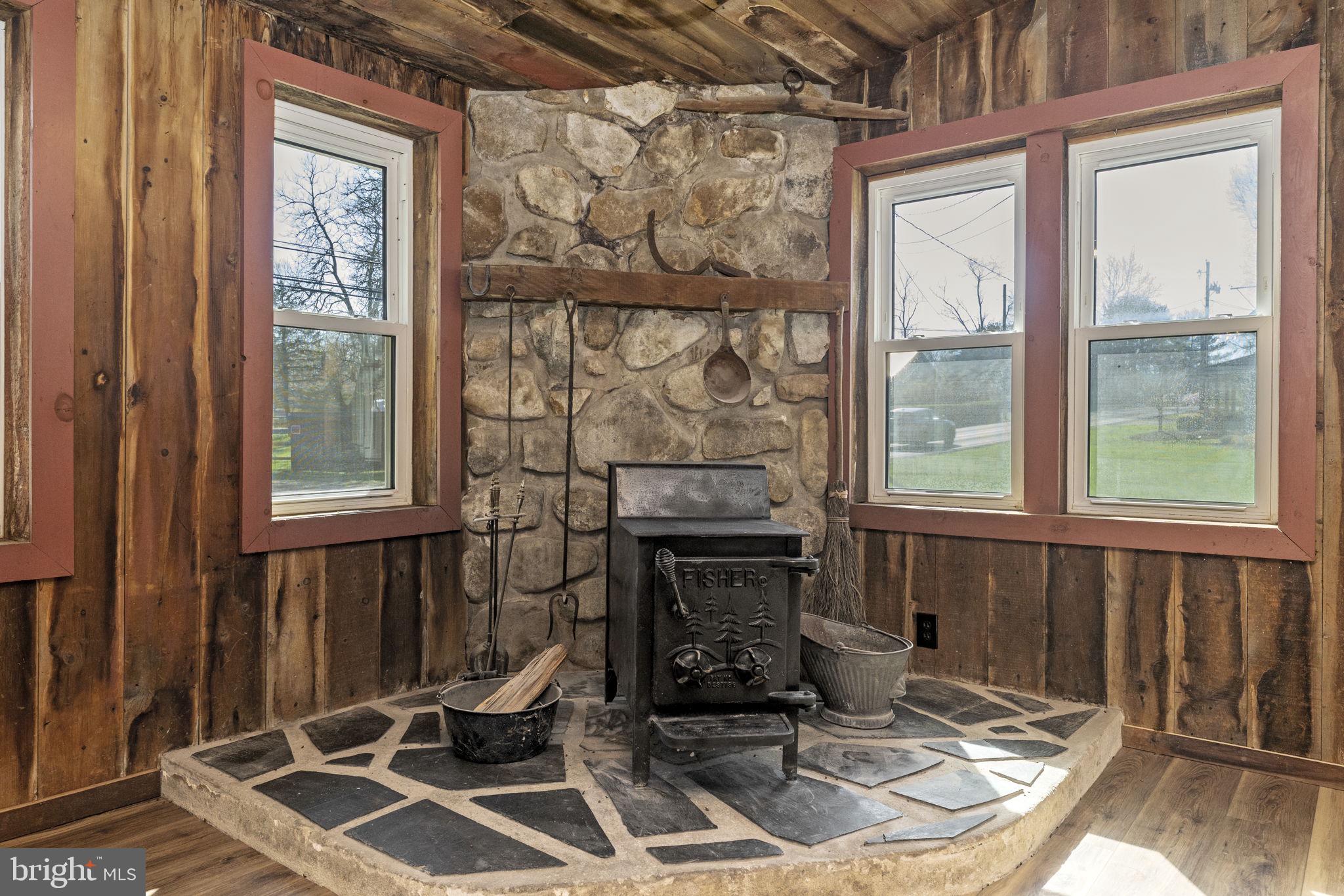 2042 Upper Ridge Road Green Lane, PA 18054 - Photo 18 of 41 Wood burning stove with stone feature wall