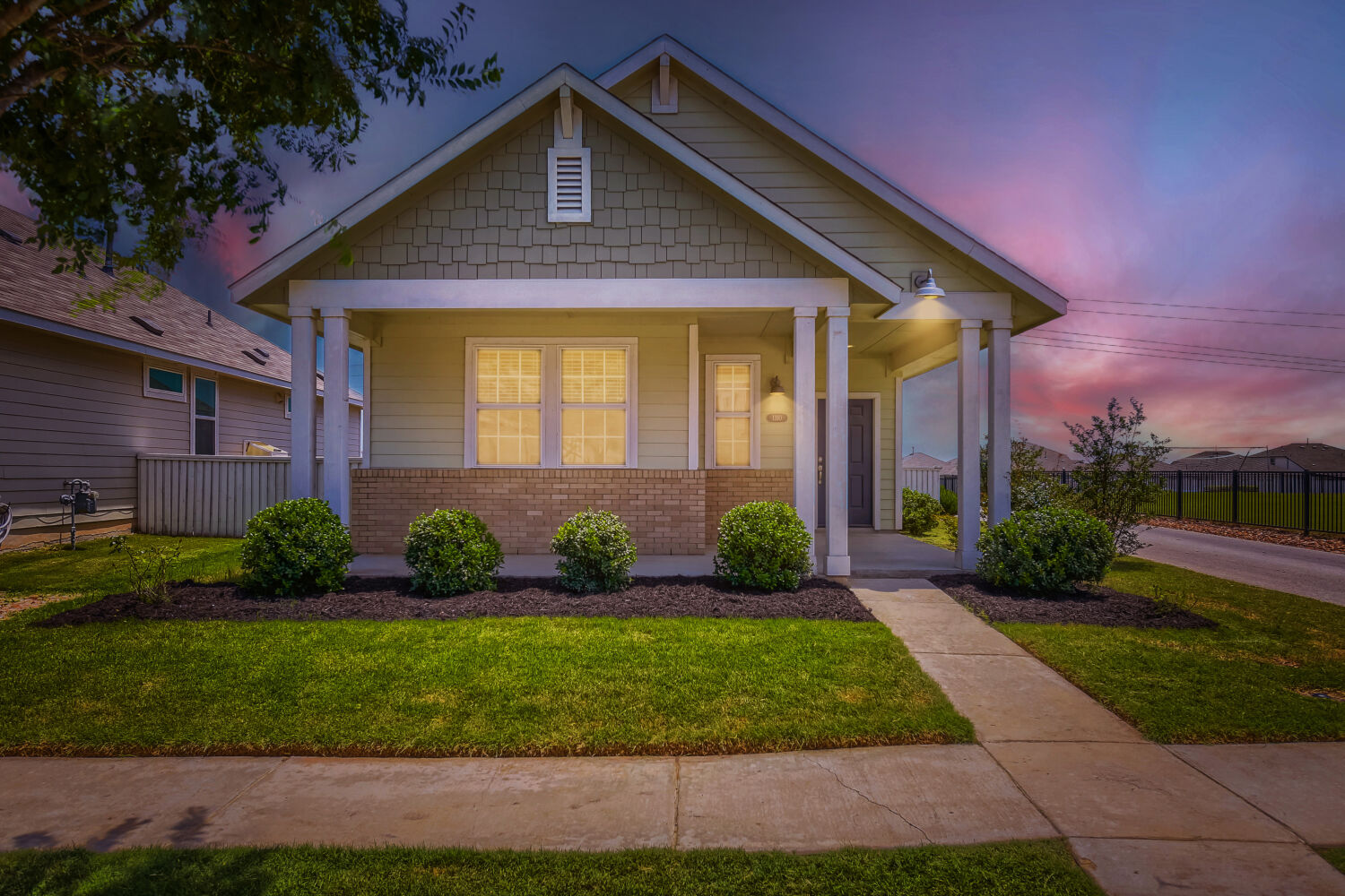 a front view of a house with a garden