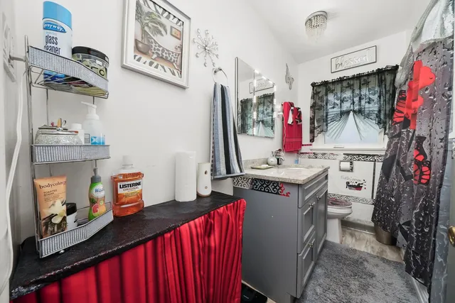 a utility room with stainless steel appliances granite countertop a stove and cabinets