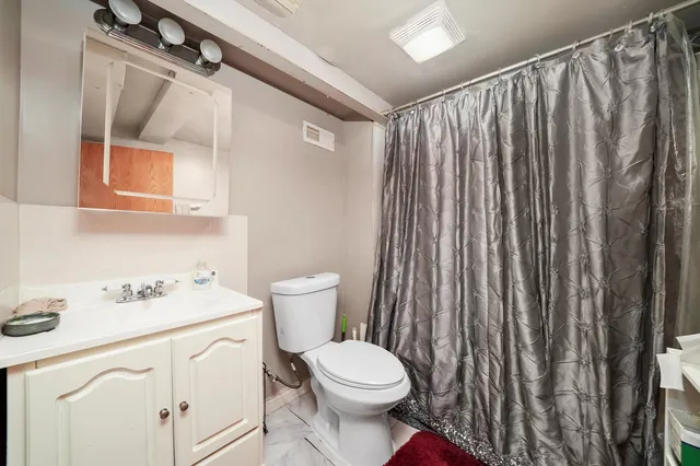 a white toilet sitting next to a bathroom sink