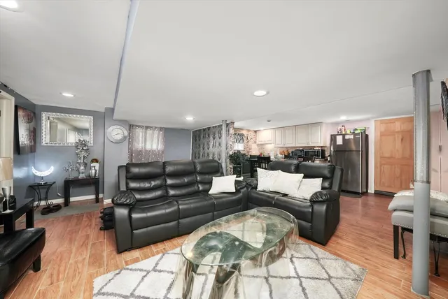 a living room with furniture and wooden floor