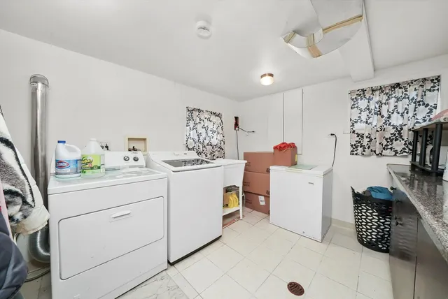 a utility room with cabinets washer and dryer