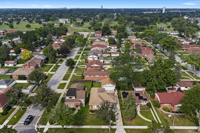 an aerial view of multiple houses with yard