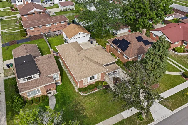 an aerial view of residential house with outdoor space and street view