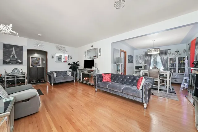 a living room with furniture and kitchen view