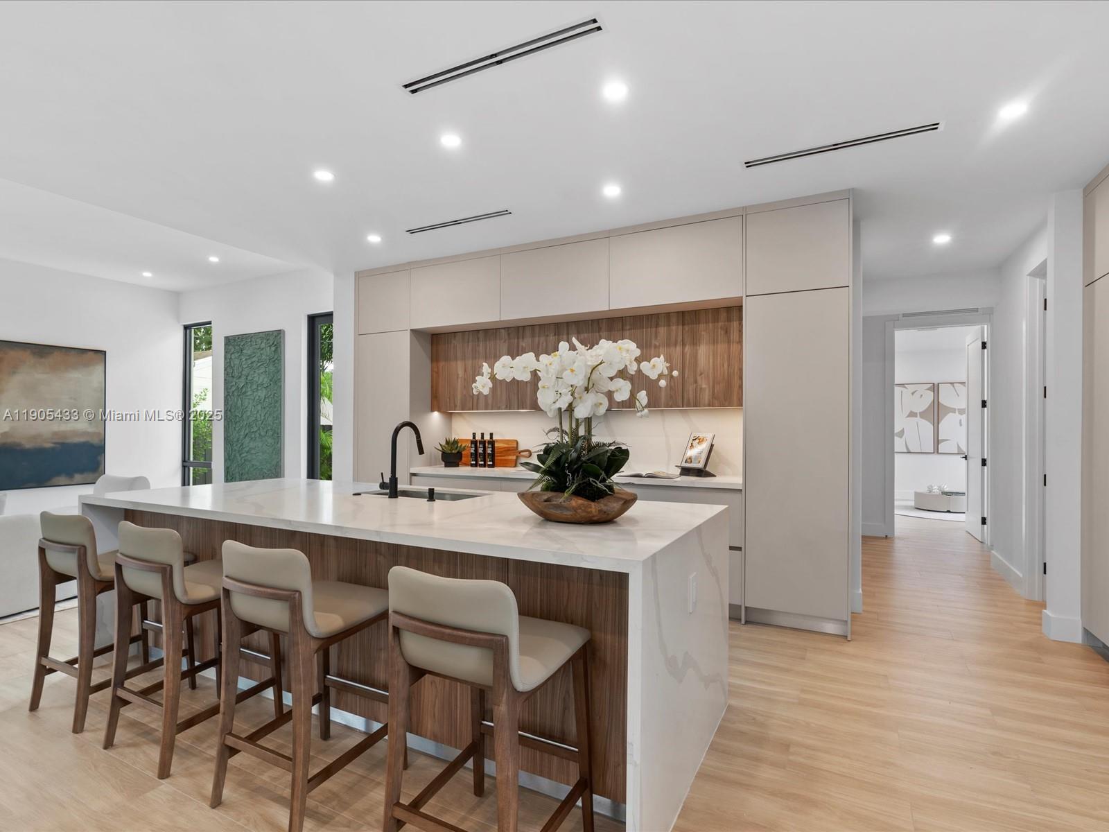 1259 Southwest 20th Street Miami, FL 33145 - Photo 22 of 61 a kitchen with stainless steel appliances kitchen island granite countertop a sink and cabinets