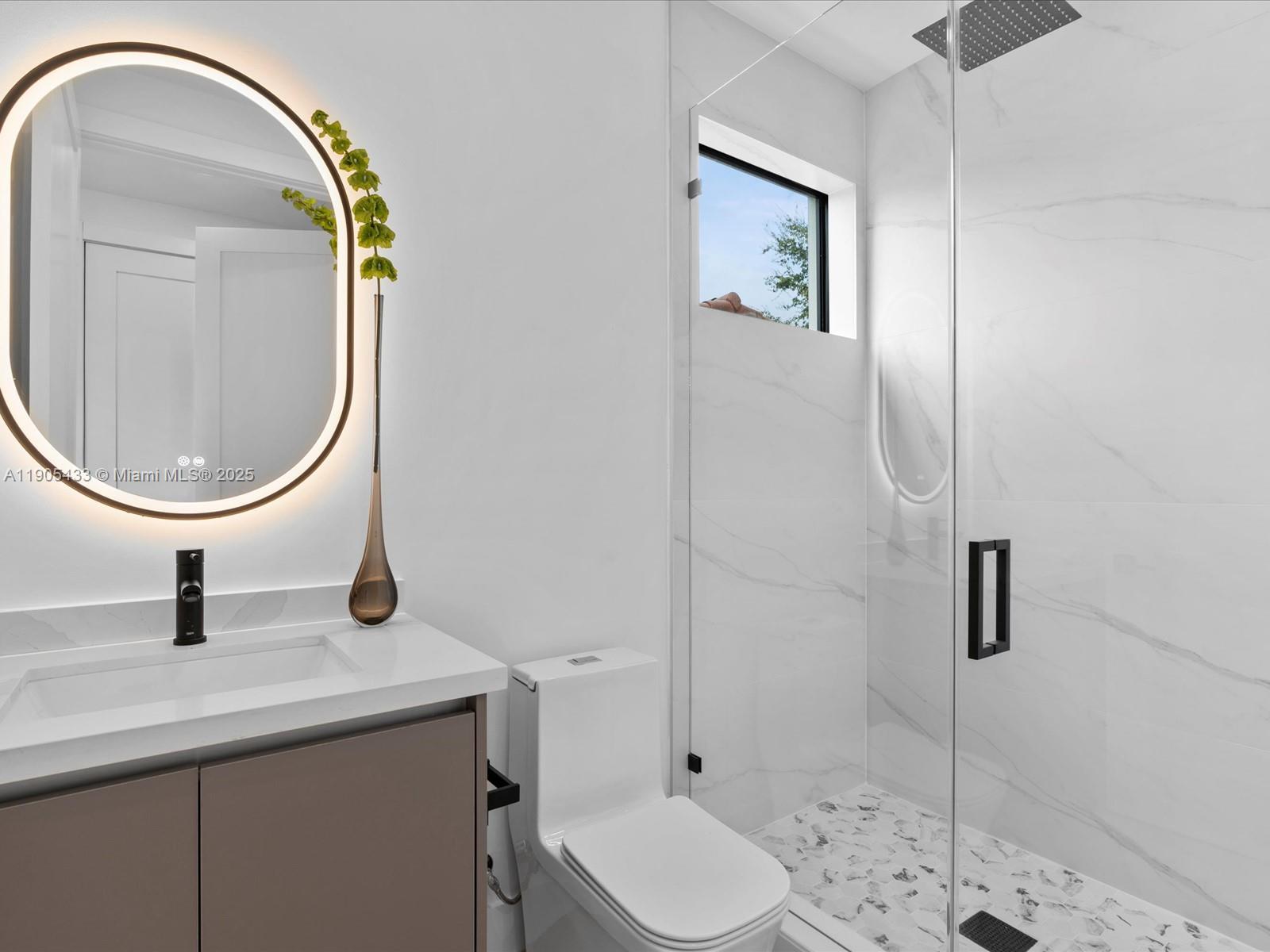 1259 Southwest 20th Street Miami, FL 33145 - Photo 35 of 61 a bathroom with a sink a toilet and a mirror