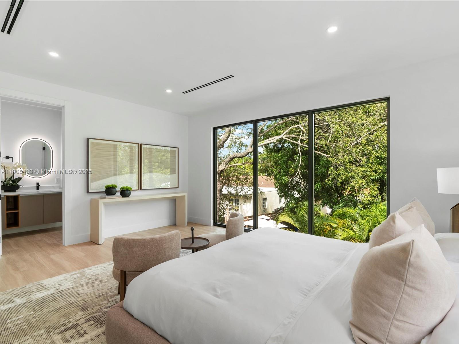 1259 Southwest 20th Street Miami, FL 33145 - Photo 41 of 61 a bedroom with a large bed and a large window