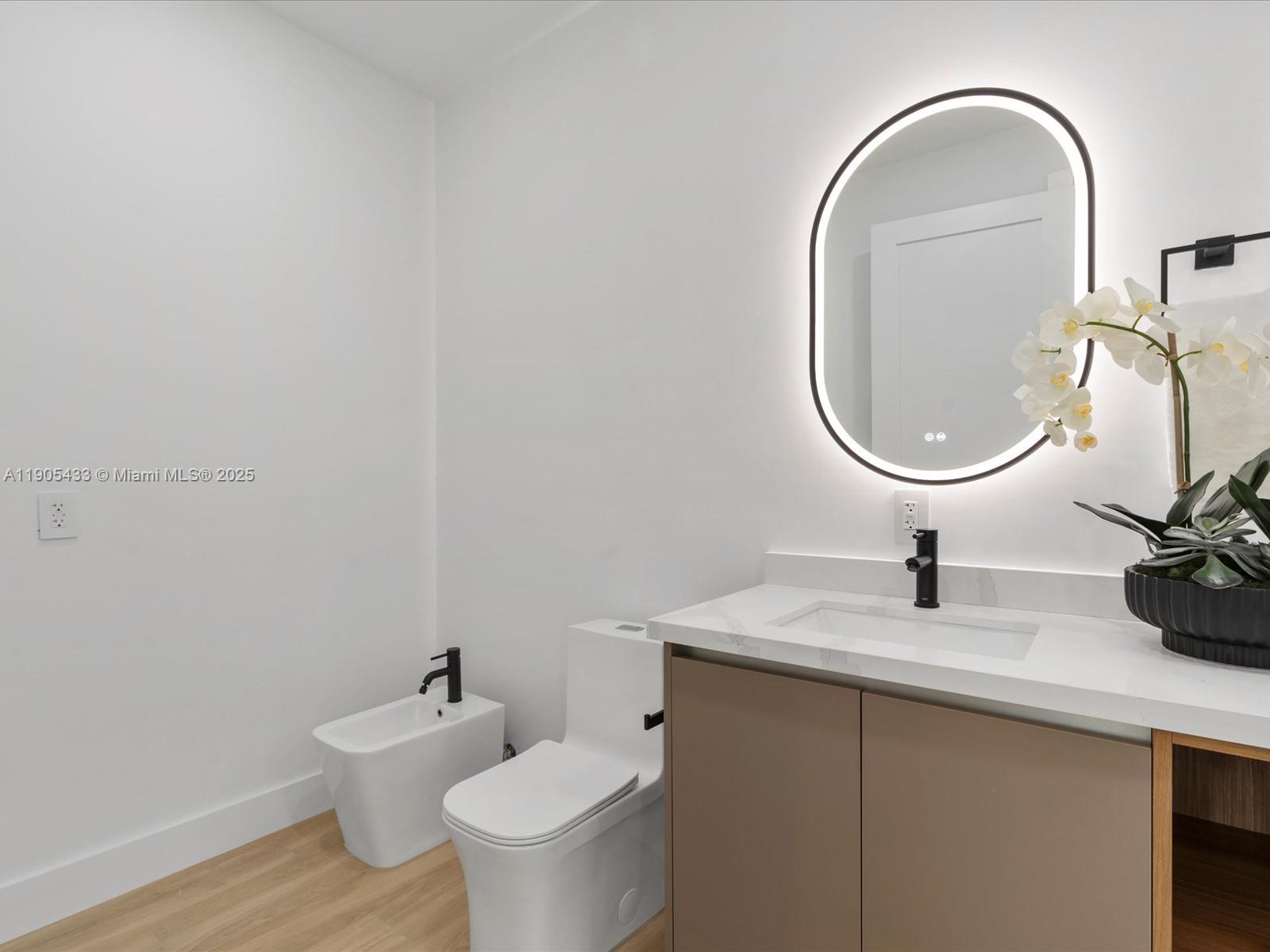 1259 Southwest 20th Street Miami, FL 33145 - Photo 44 of 61 a bathroom with a toilet a sink and mirror