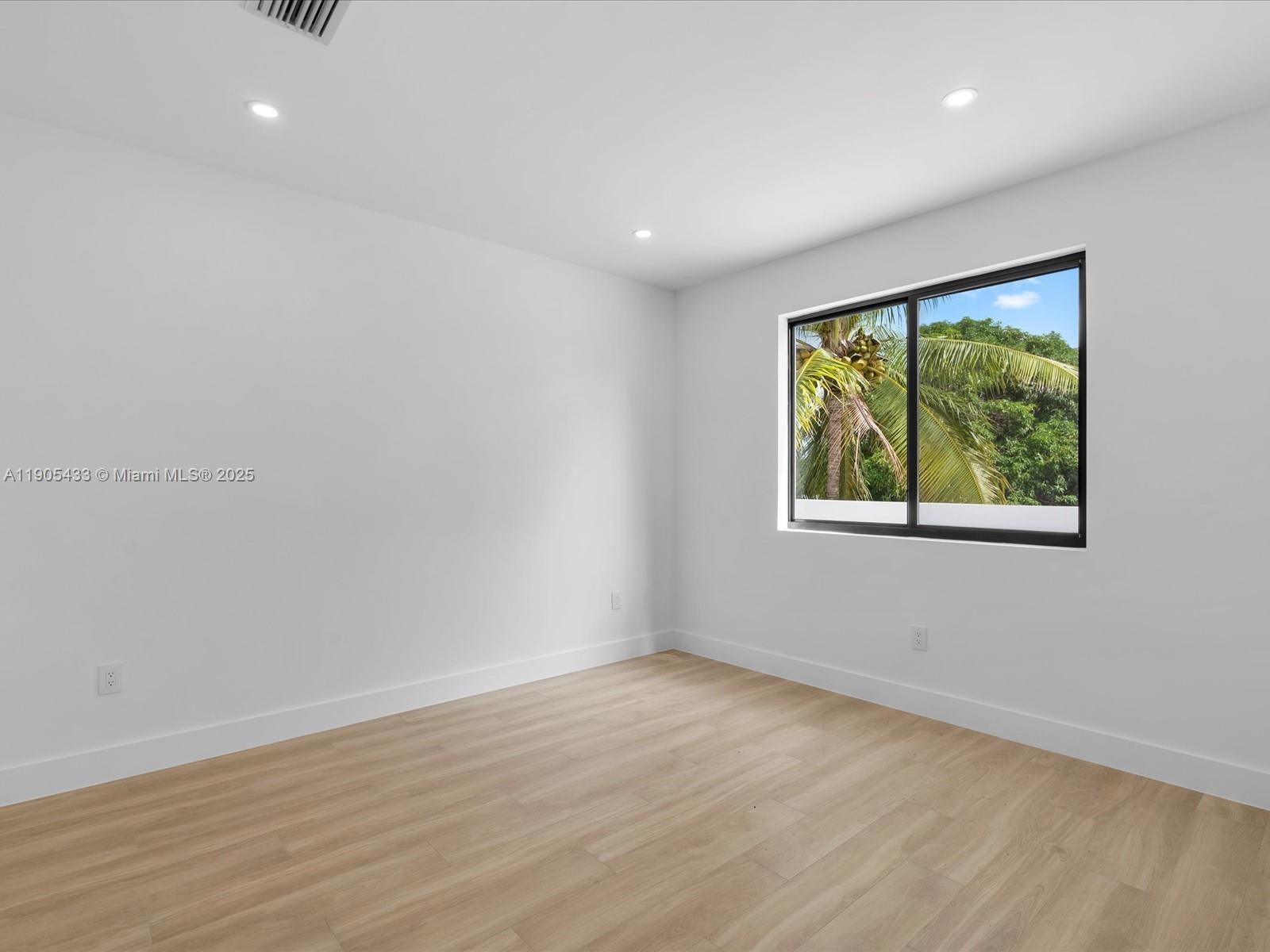 1259 Southwest 20th Street Miami, FL 33145 - Photo 46 of 61 a view of an empty room with wooden floor and windows