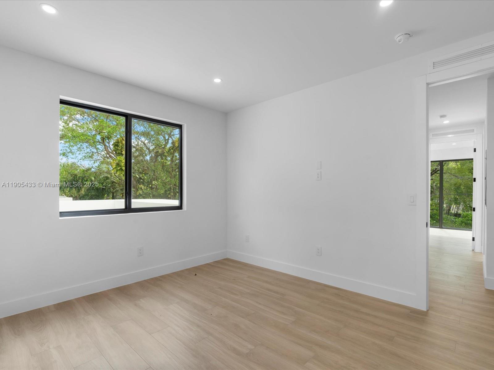 1259 Southwest 20th Street Miami, FL 33145 - Photo 47 of 61 a view of an empty room with wooden floor and a window