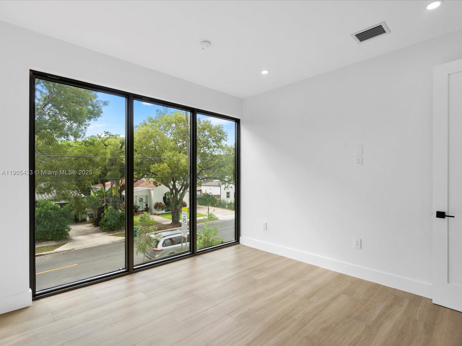 1259 Southwest 20th Street Miami, FL 33145 - Photo 52 of 61 a view of a big room with wooden floor and doors