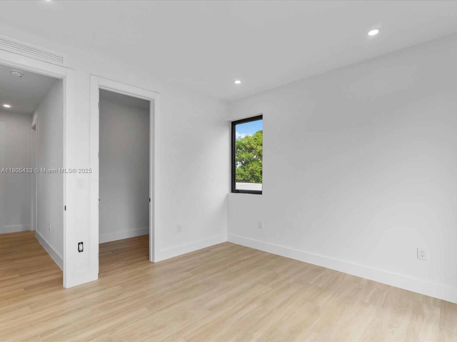 1259 Southwest 20th Street Miami, FL 33145 - Photo 54 of 61 an empty room with wooden floor and window
