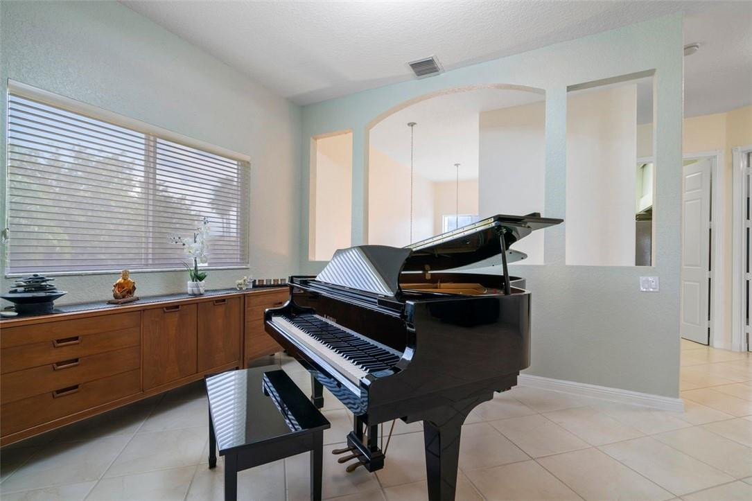 7847 Exeter Boulevard East, Unit 203 Tamarac, FL 33321 - Photo 13 of 36 a bedroom with a bed and a window