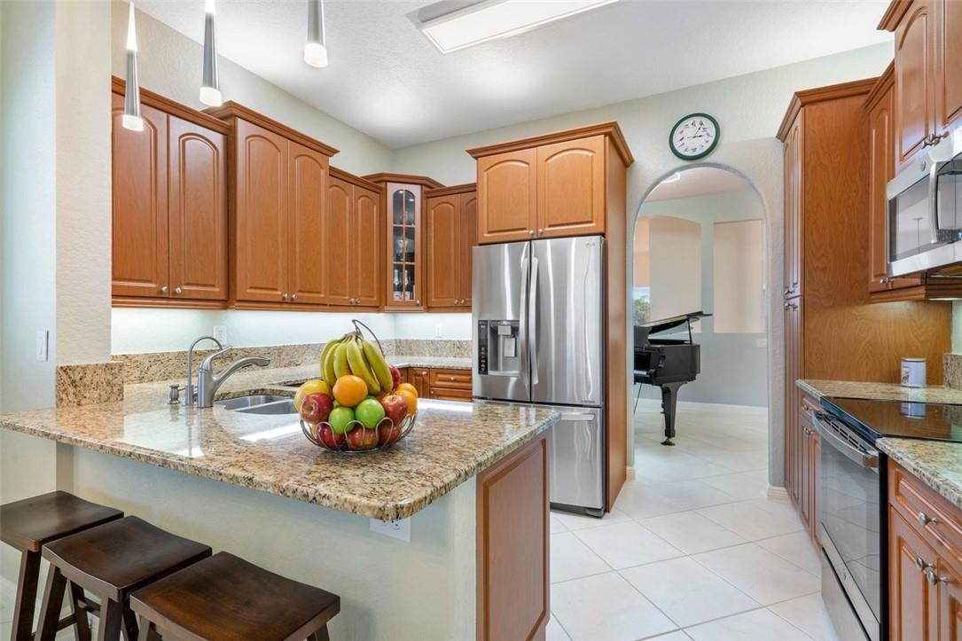 7847 Exeter Boulevard East, Unit 203 Tamarac, FL 33321 - Photo 15 of 36 a kitchen with stainless steel appliances granite countertop a sink refrigerator and cabinets