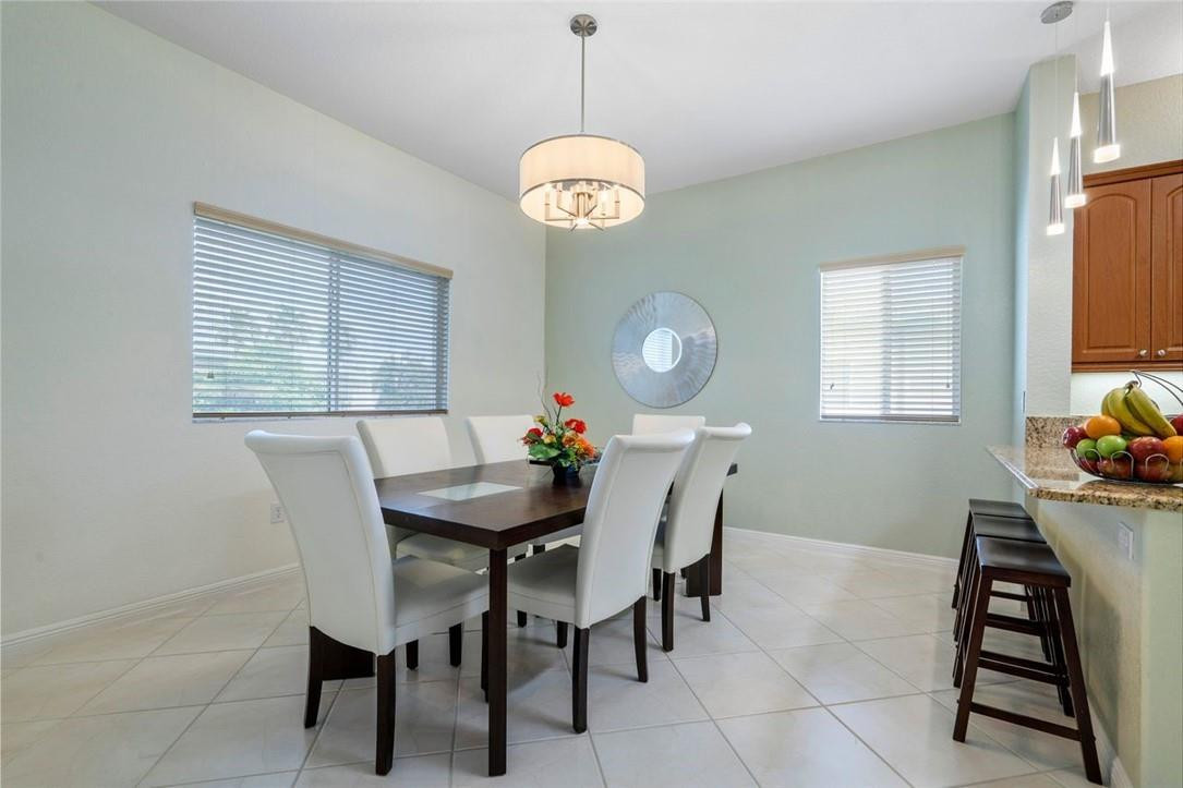 7847 Exeter Boulevard East, Unit 203 Tamarac, FL 33321 - Photo 19 of 36 a view of a dining room with a table and chairs