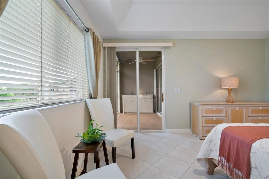 7847 Exeter Boulevard East, Unit 203 Tamarac, FL 33321 - Photo 21 of 36 a bedroom with a bed and a potted plant