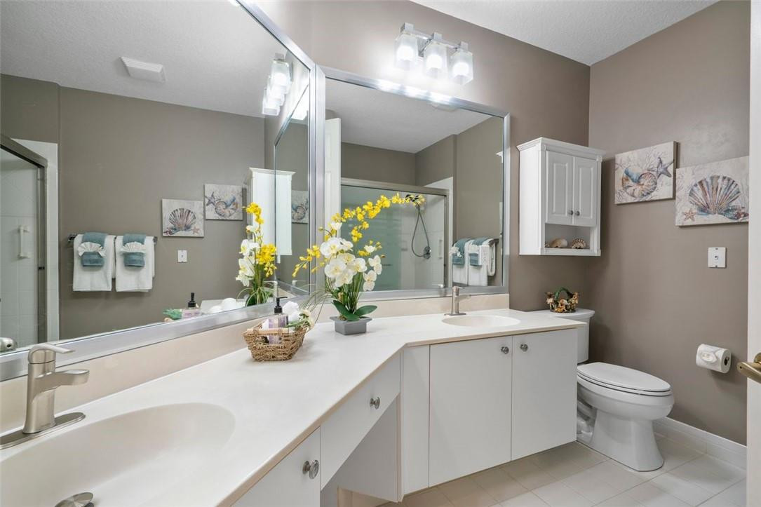 7847 Exeter Boulevard East, Unit 203 Tamarac, FL 33321 - Photo 23 of 36 a bathroom with a sink double vanity and a toilet