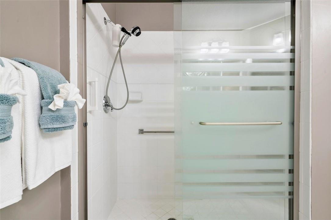 7847 Exeter Boulevard East, Unit 203 Tamarac, FL 33321 - Photo 24 of 36 a bathroom with a glass shower door