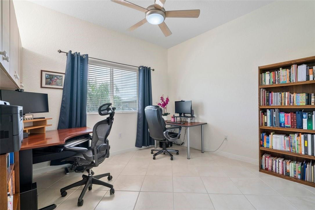 7847 Exeter Boulevard East, Unit 203 Tamarac, FL 33321 - Photo 25 of 36 a view of a workspace with furniture and a bookshelf