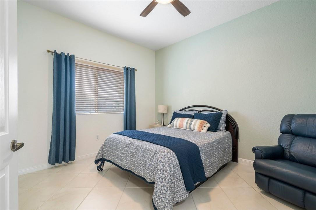 7847 Exeter Boulevard East, Unit 203 Tamarac, FL 33321 - Photo 26 of 36 a bedroom with a bed couch and window