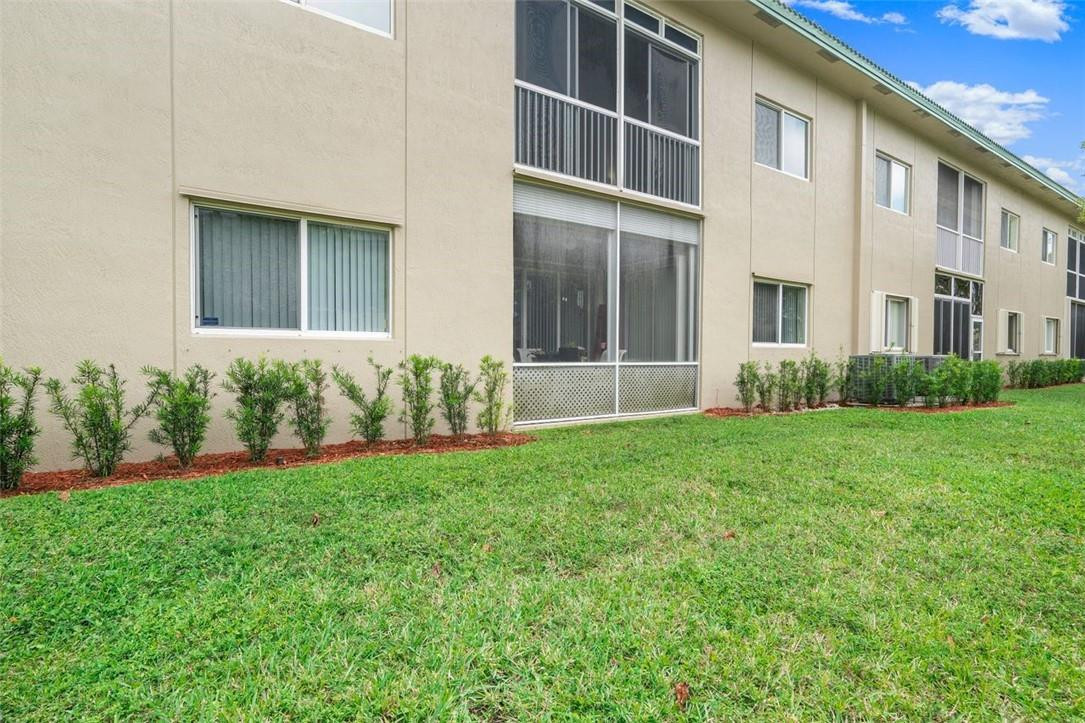 7847 Exeter Boulevard East, Unit 203 Tamarac, FL 33321 - Photo 32 of 36 front view of a house with a yard