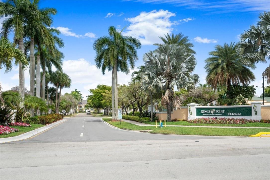 7847 Exeter Boulevard East, Unit 203 Tamarac, FL 33321 - Photo 36 of 36 a view of a swimming pool with palm trees