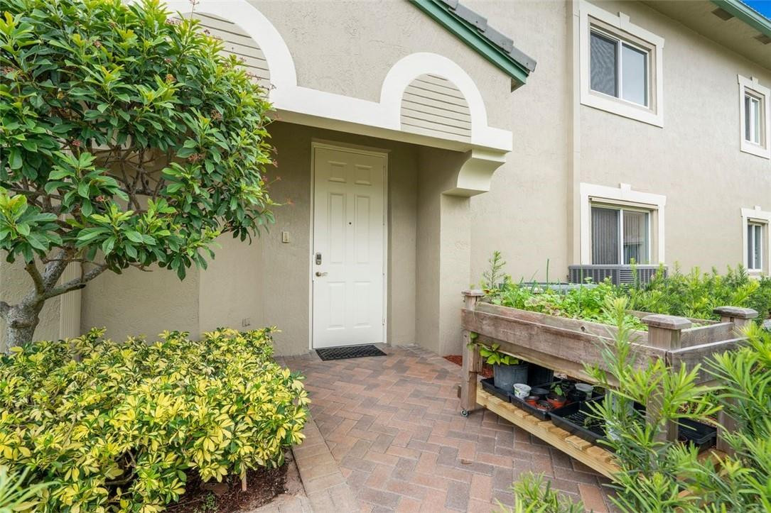 7847 Exeter Boulevard East, Unit 203 Tamarac, FL 33321 - Photo 5 of 36 a front view of a house with a yard