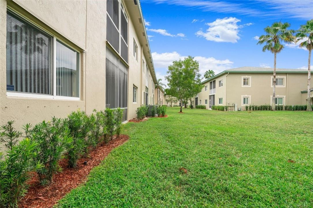 7847 Exeter Boulevard East, Unit 203 Tamarac, FL 33321 - Photo 6 of 36 a view of a house with a yard