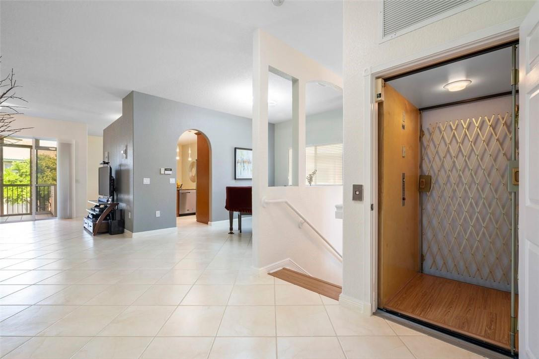 7847 Exeter Boulevard East, Unit 203 Tamarac, FL 33321 - Photo 9 of 36 a view of a hallway with a livingroom and dining room view