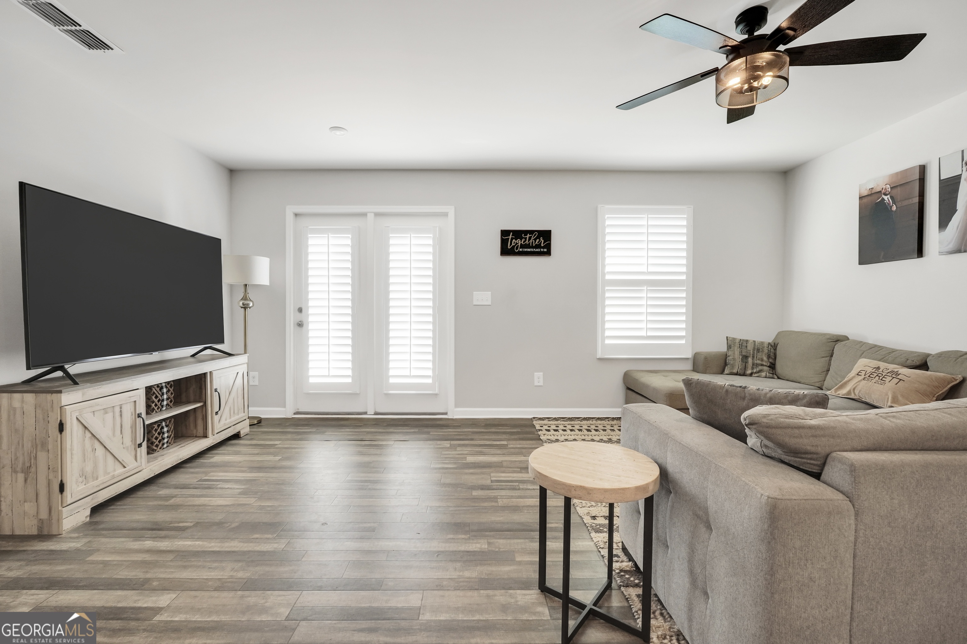 140 Catalpa Road Milner, GA 30257 - Photo 16 of 32 a living room with furniture and a flat screen tv
