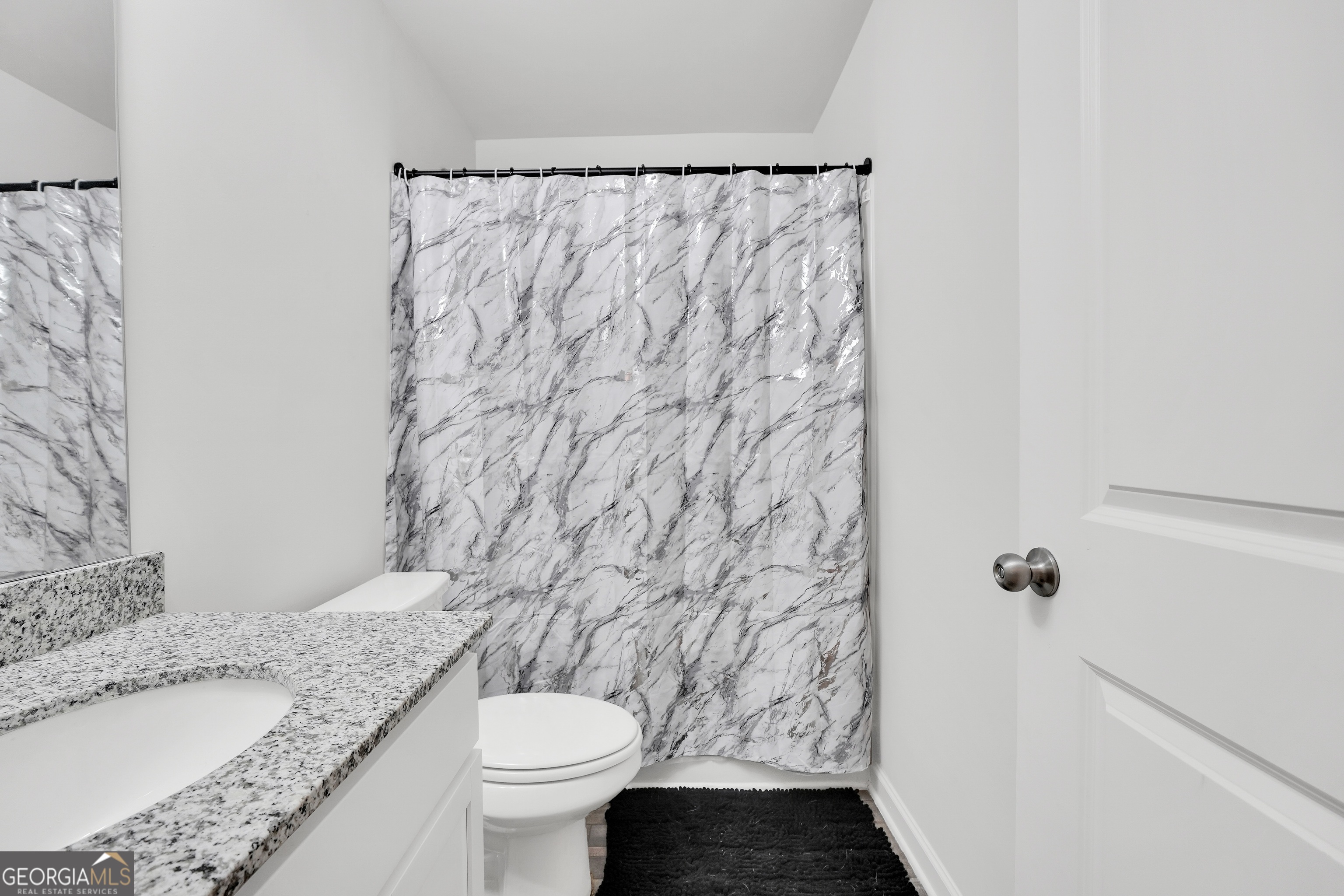140 Catalpa Road Milner, GA 30257 - Photo 27 of 32 a bathroom with a granite countertop sink and a toilet