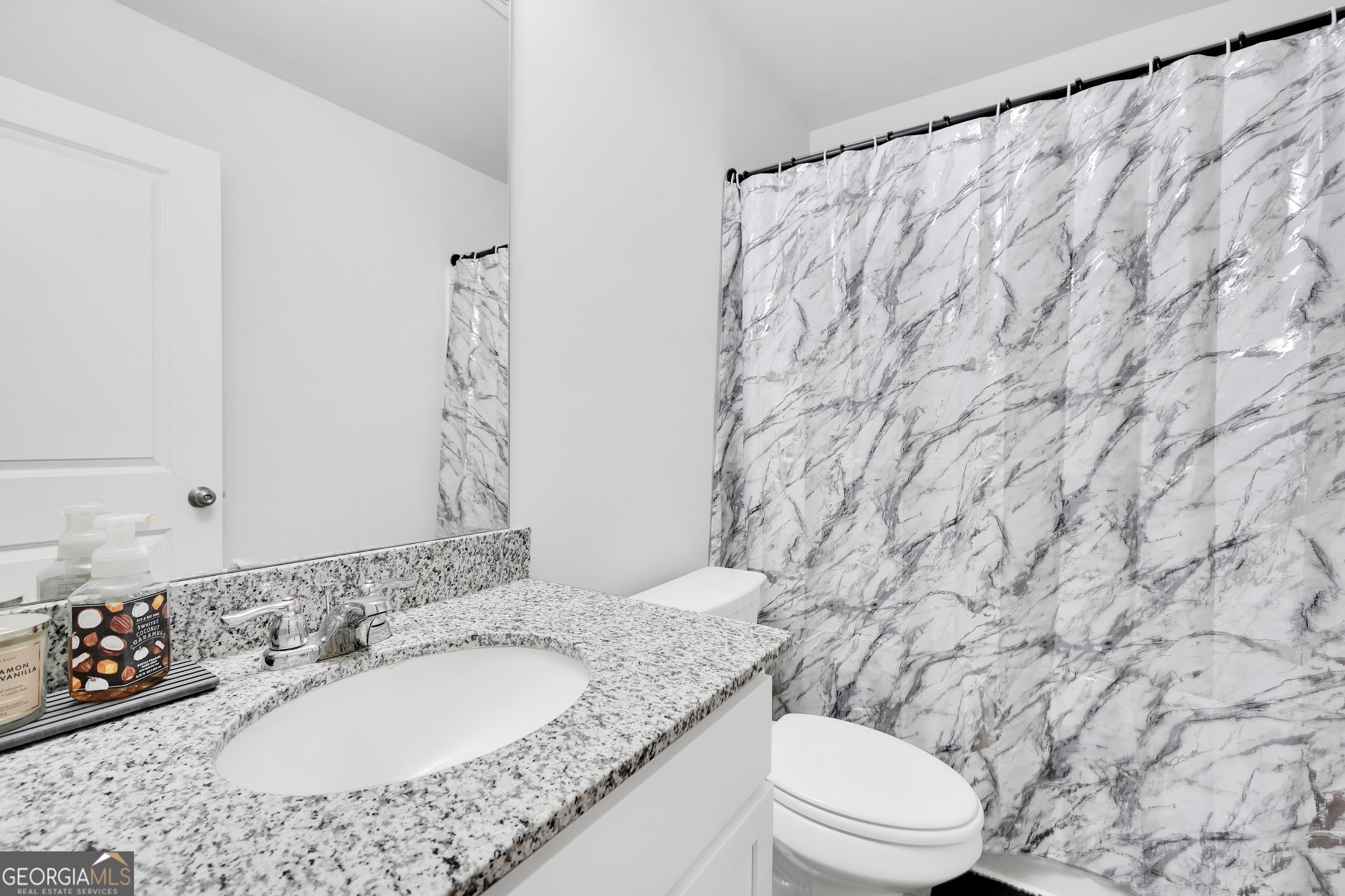 140 Catalpa Road Milner, GA 30257 - Photo 28 of 32 a bathroom with a granite countertop sink and a mirror
