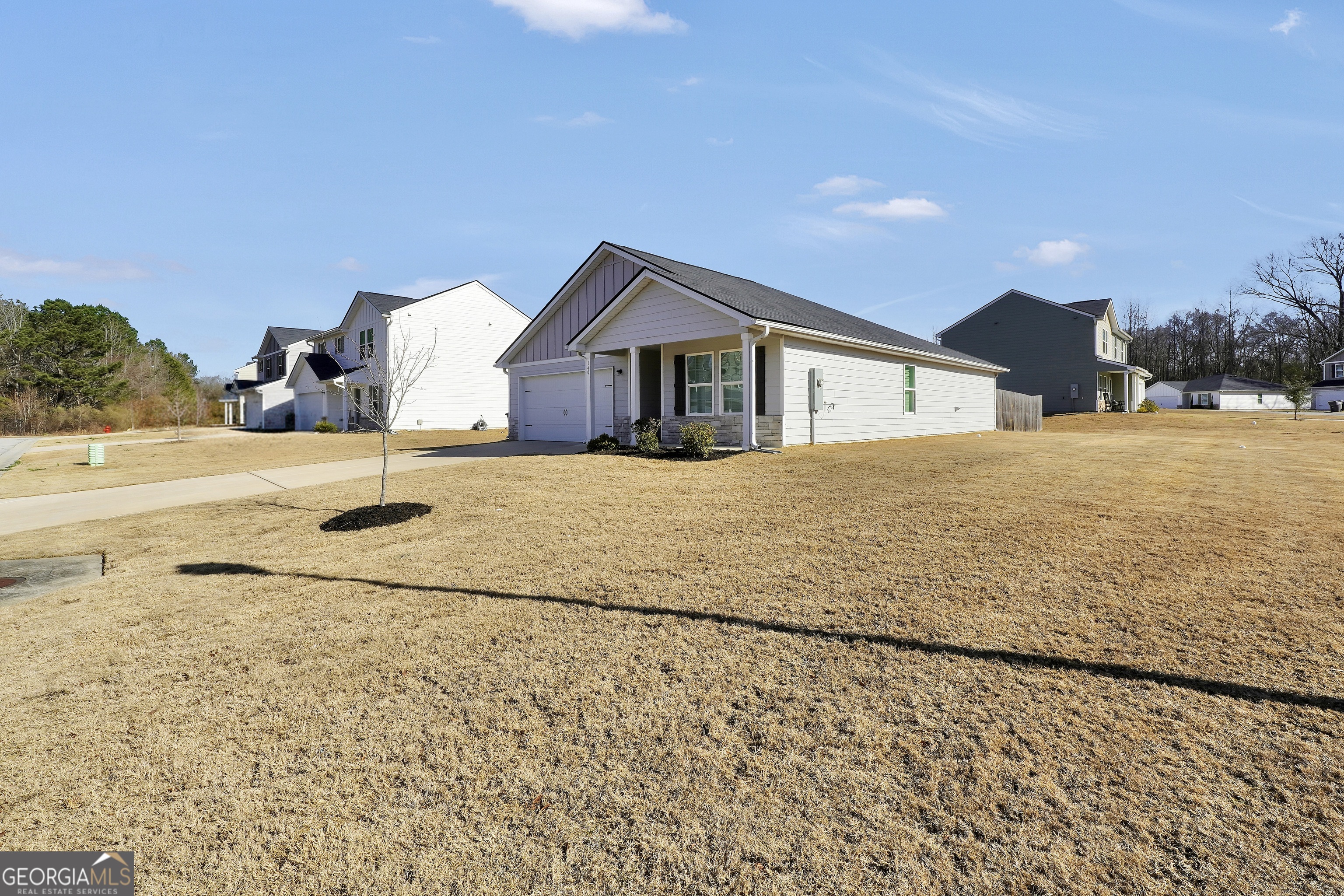 140 Catalpa Road Milner, GA 30257 - Photo 5 of 32 a view of white house with a yard