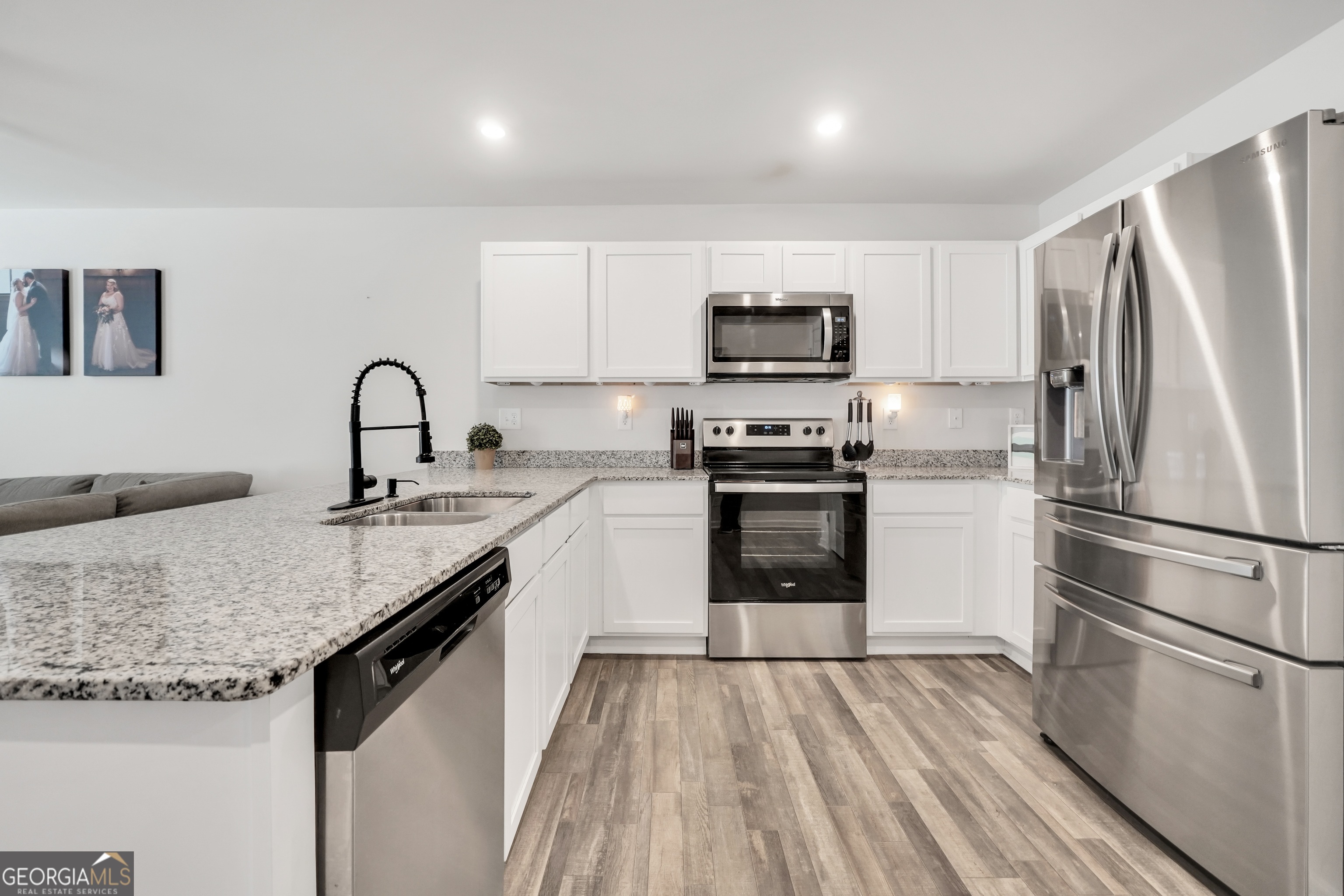 140 Catalpa Road Milner, GA 30257 - Photo 7 of 32 a kitchen with kitchen island granite countertop a sink stainless steel appliances and counter space
