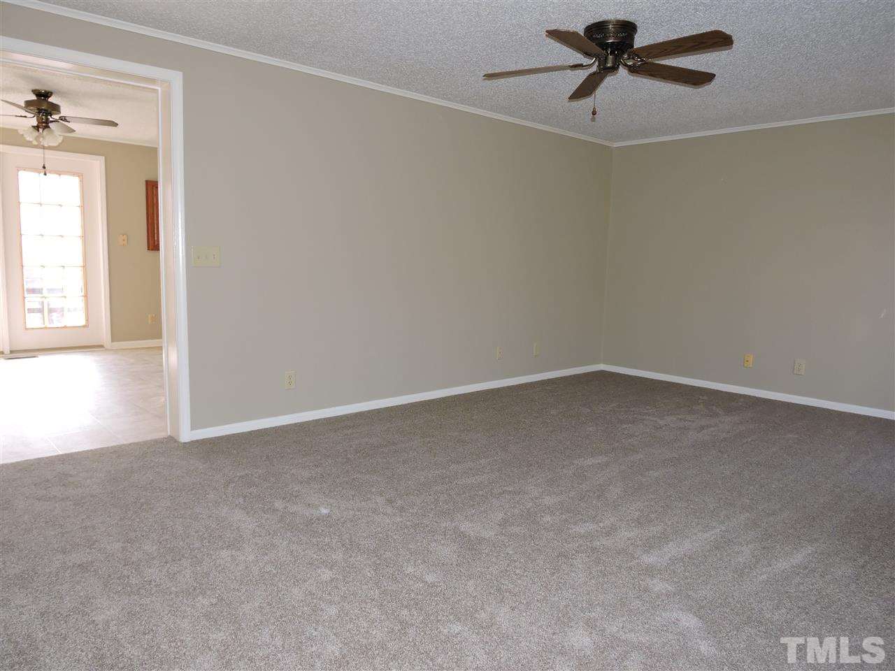 250 Kiser Hicks Road Roxboro, NC 27574 - Photo 3 of 19 an empty room with a window and a ceiling fan