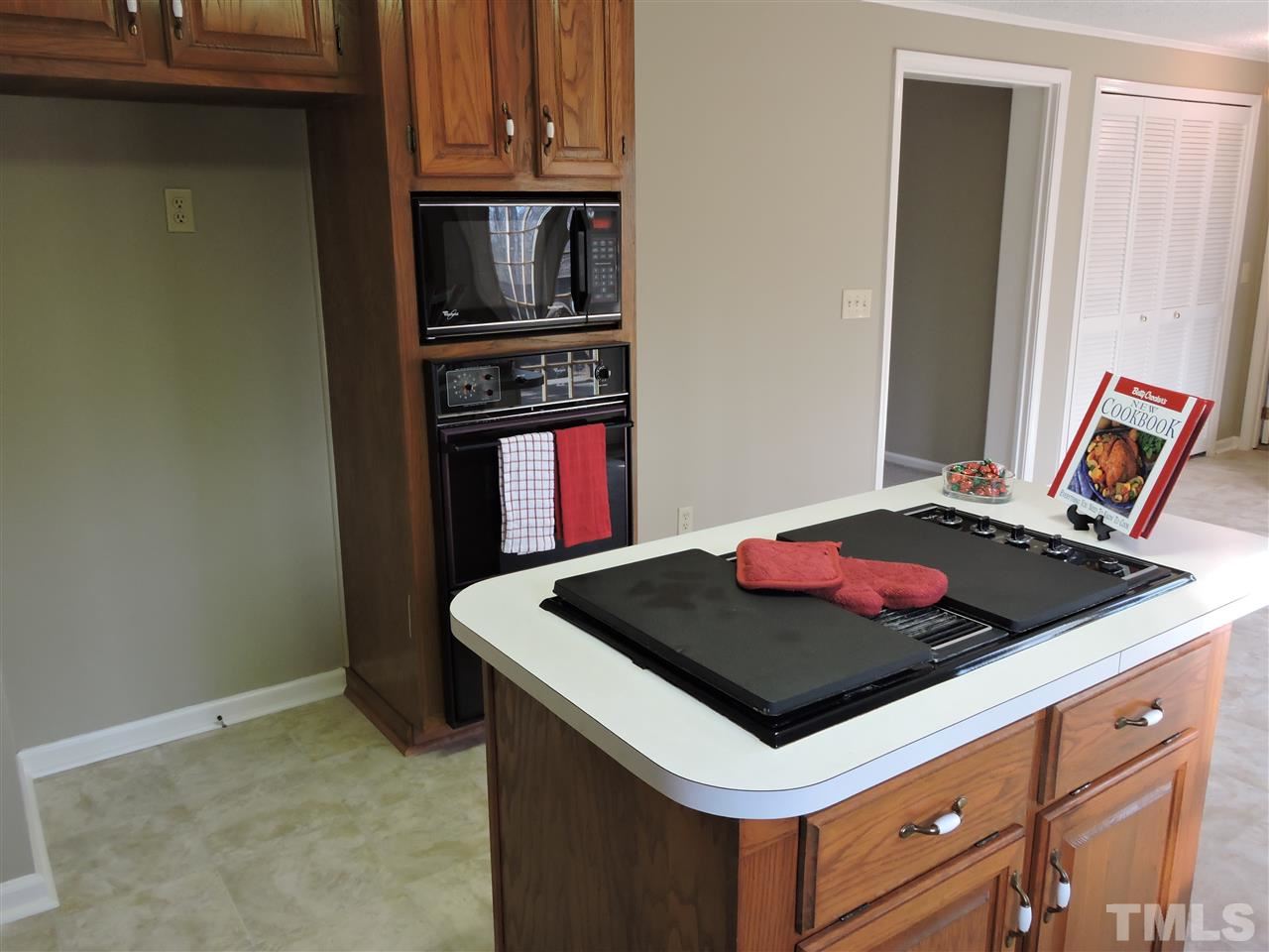 250 Kiser Hicks Road Roxboro, NC 27574 - Photo 6 of 19 a stove top oven sitting inside of a kitchen