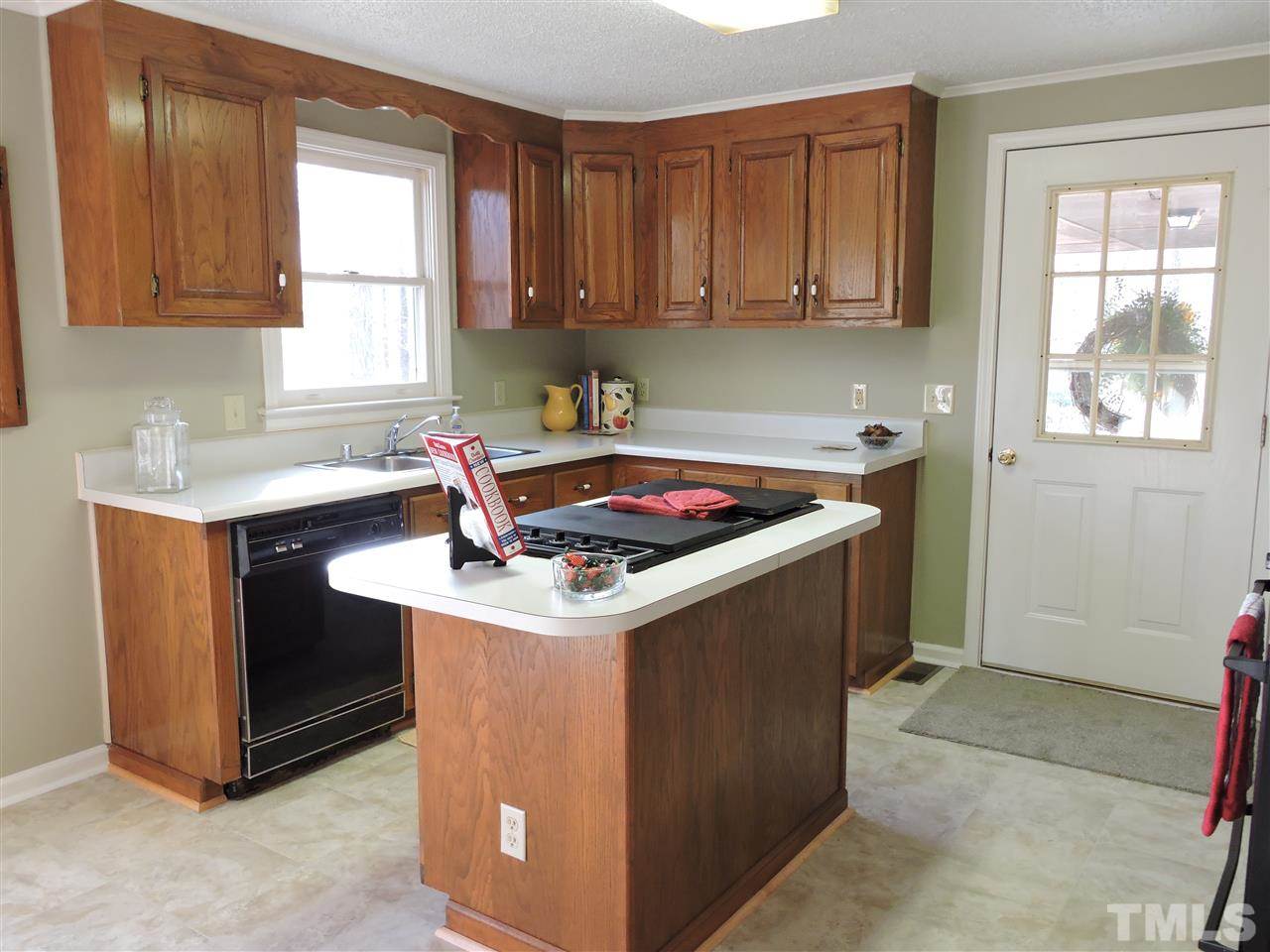 250 Kiser Hicks Road Roxboro, NC 27574 - Photo 7 of 19 a kitchen with a stove and a sink