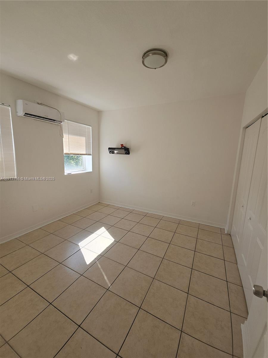 1021 Northwest 3rd Street, Unit 301 Miami, FL 33128 - Photo 2 of 9 a view of an empty room and window