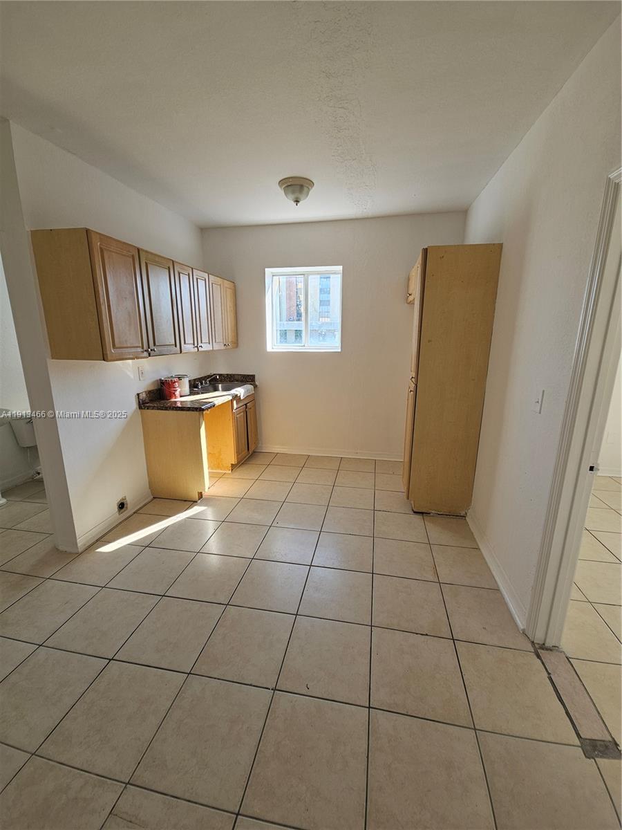 1021 Northwest 3rd Street, Unit 301 Miami, FL 33128 - Photo 5 of 9 a view of an empty room with a window