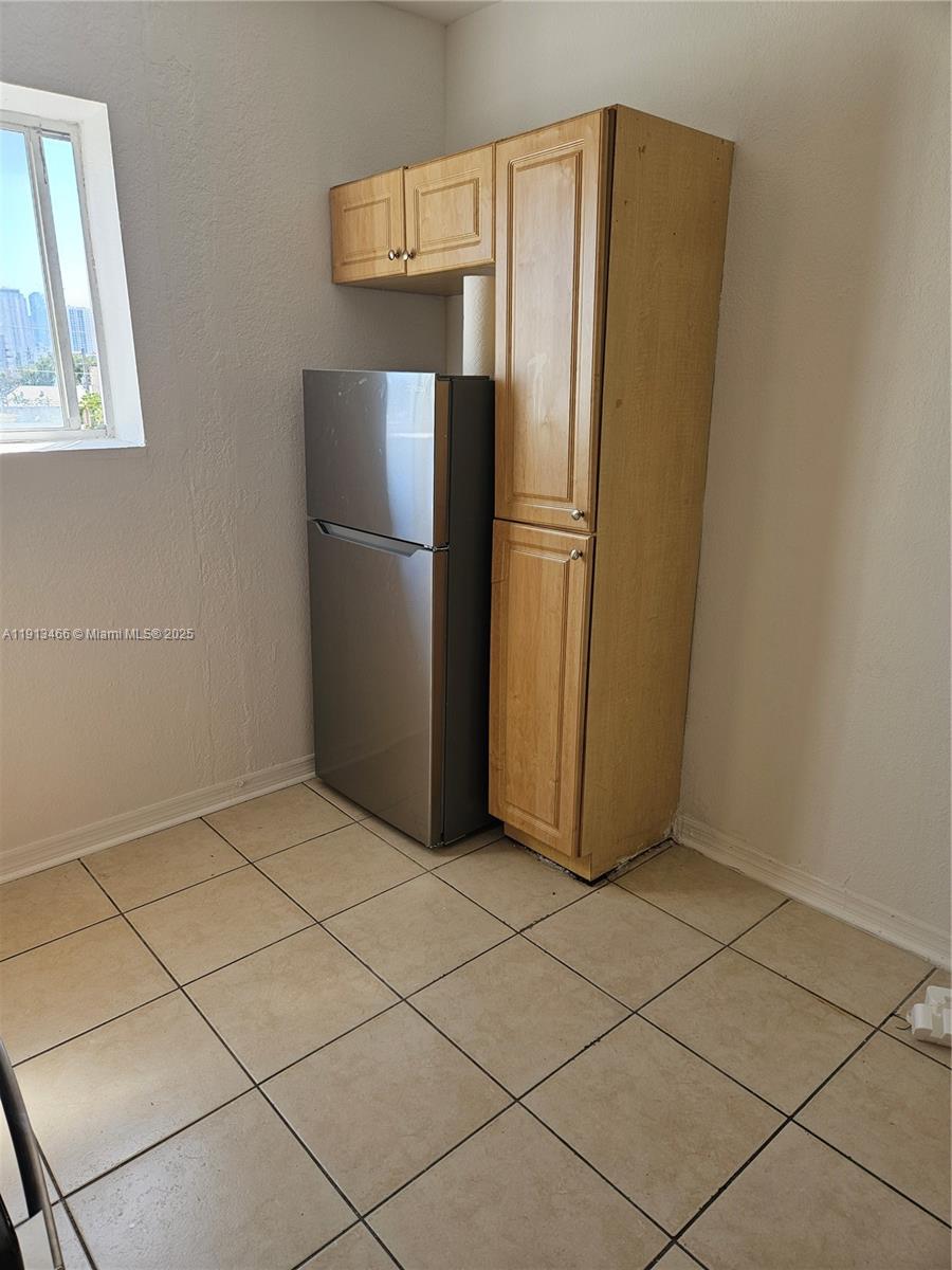 1021 Northwest 3rd Street, Unit 301 Miami, FL 33128 - Photo 8 of 9 a view of a refrigerator in kitchen and an empty room