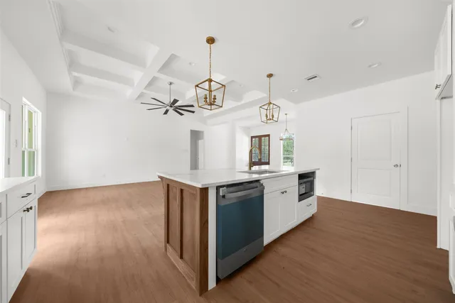 a kitchen with a stove a sink and a refrigerator