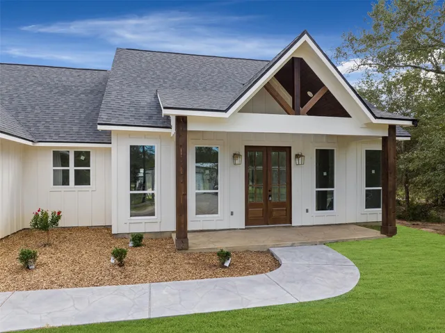 a front view of a house with garden
