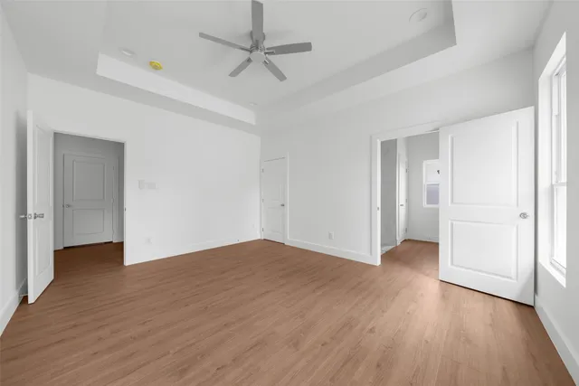 a view of an empty room with wooden floor