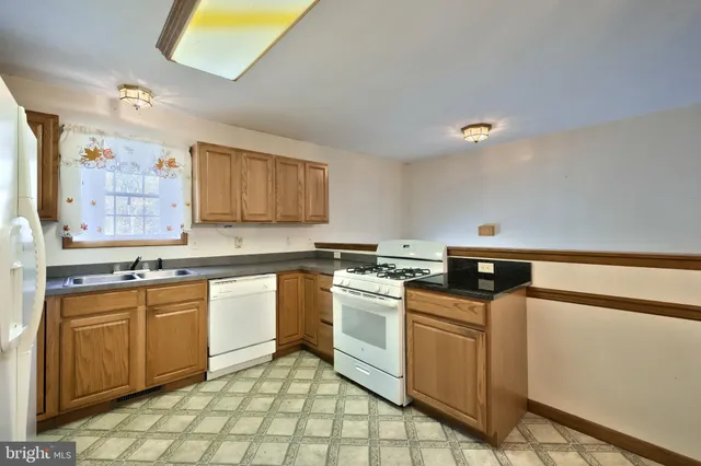 a white toilet sitting next to a bathroom sink