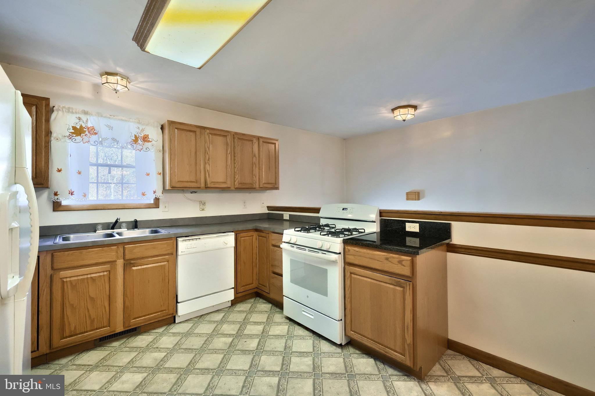 200 Slate Rock Road Biglerville, PA 17307 - Photo 6 of 43 a kitchen with stainless steel appliances granite countertop a stove a sink and a microwave