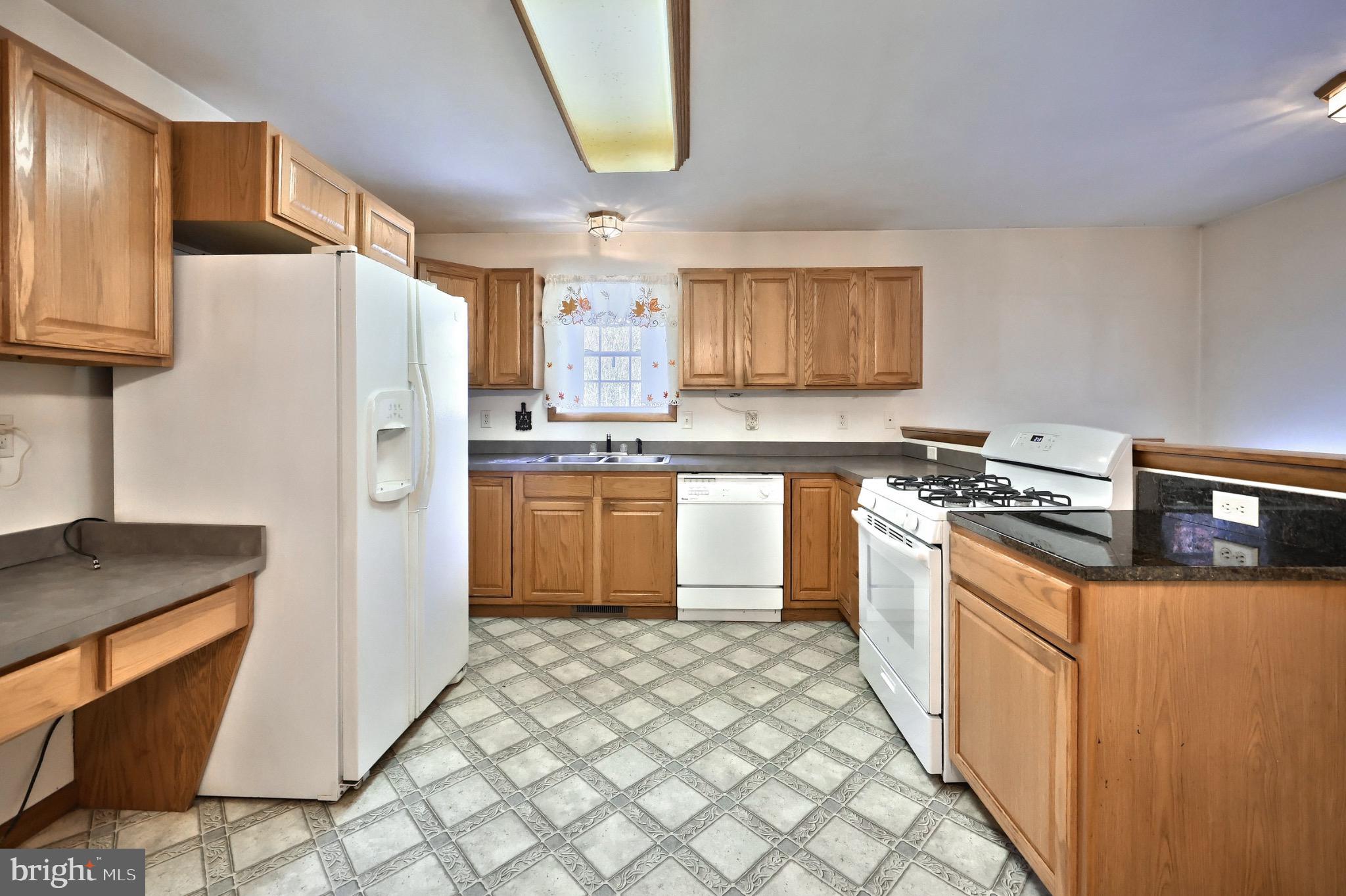 200 Slate Rock Road Biglerville, PA 17307 - Photo 7 of 43 a kitchen with stainless steel appliances granite countertop a stove a sink dishwasher and a refrigerator