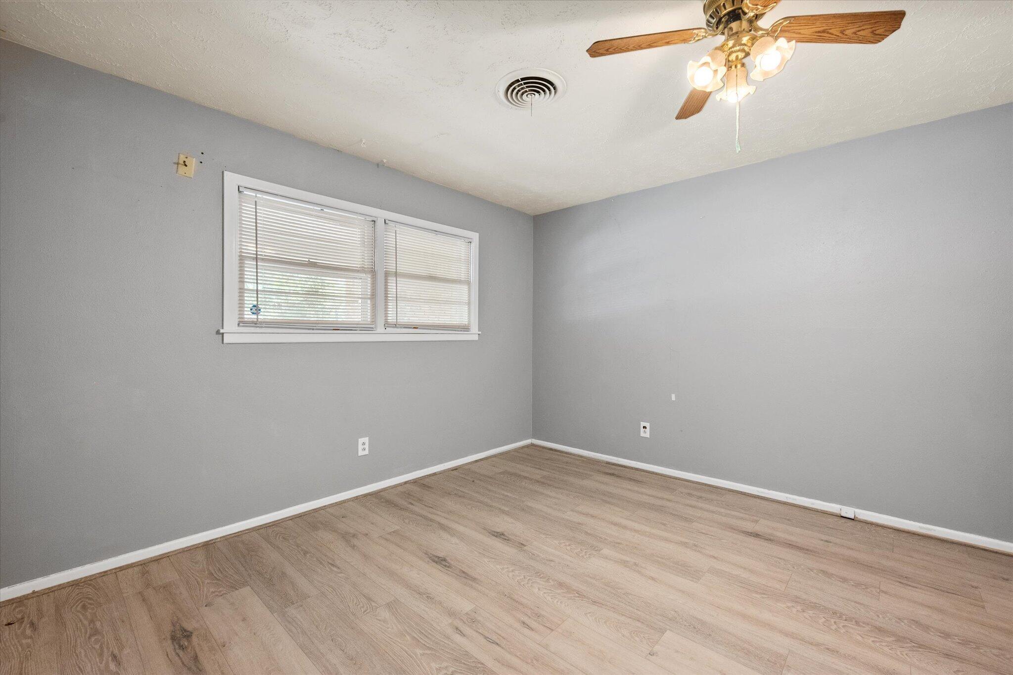 4604 27th Street Lubbock, TX 79410 - Photo 7 of 36 wooden floor in an empty room with a window