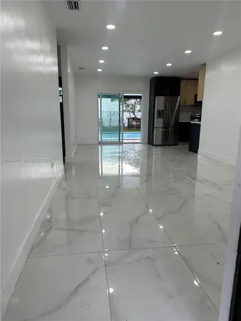 a view of a hallway with seating area